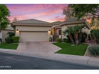 Charming single-story home featuring a neutral color palette, desert landscaping, and a spacious two-car garage at 7425 E Gainey Ranch Rd # 13, Scottsdale, AZ 85258