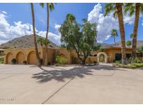 Stunning home exterior featuring desert landscaping and a spacious driveway with mountain views at 7816 N 47Th St, Paradise Valley, AZ 85253