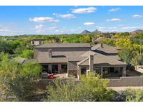 Luxury home featuring a tile roof, desert landscaping, mountain views, and a private outdoor living space at 9280 E Thompson Peak Pkwy # 39, Scottsdale, AZ 85255