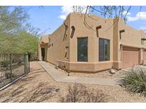 Exterior view of the home showcasing its southwestern architecture and desert landscaping at 6088 E Knolls N Way, Cave Creek, AZ 85331