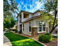 Charming two-story home featuring stone accents, lush landscaping, and a private balcony at 17749 W Woodrow Ln, Surprise, AZ 85388