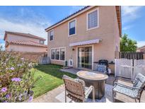 Outdoor patio with a fire pit and chairs, plus grass area and block fence at 3433 S Chaparral Rd, Apache Junction, AZ 85119