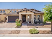 Charming home with a well-manicured lawn, desert landscaping, a covered porch, and brick paver driveway at 3871 E Harrison St, Gilbert, AZ 85295