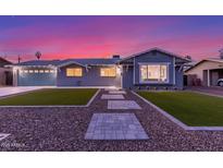 Charming single-story home with a well-manicured lawn, lovely walkway, and two-car garage at 8522 E Virginia Ave, Scottsdale, AZ 85257