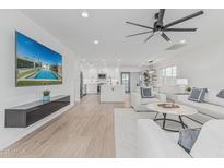 Open concept living area showcases sleek mounted television, bright kitchen, and modern furniture at 8522 E Virginia Ave, Scottsdale, AZ 85257