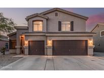 Inviting two-story home featuring a neutral color palette and a spacious two-car garage for convenient parking and storage at 12376 W Hazelwood St, Avondale, AZ 85392