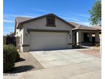 Charming single-story home featuring a two-car garage, a modern roof, and a well-maintained front yard at 15461 W Jefferson St, Goodyear, AZ 85338