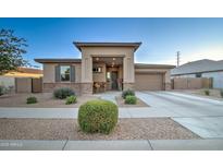 Charming single-story home with a welcoming front porch and well-maintained desert landscaping at 22601 E Via Las Brisas --, Queen Creek, AZ 85142