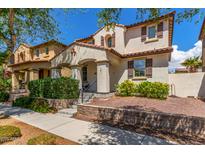 Charming two-story home features a well-maintained front yard with lush landscaping and a welcoming entrance at 2435 N Riley Rd, Buckeye, AZ 85396