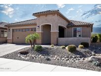 Charming home featuring desert landscaping with a tile roof and covered entryway at 26421 W Zachary Dr, Buckeye, AZ 85396