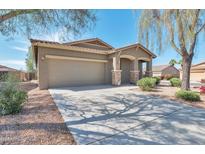 Charming single-story home featuring a two car garage, covered porch, and desert landscaping at 7433 W Darrel Rd, Laveen, AZ 85339