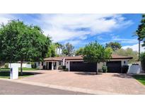 Beautiful single-story home with lush landscaping, brick driveway, and attached garage at 8031 N 12Th Ave, Phoenix, AZ 85021