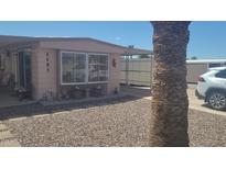 Inviting home exterior featuring a covered front porch and desert landscaping at 8609 E Dewberry Ave, Mesa, AZ 85208