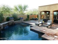 Inviting backyard pool area with patio, lounge chairs, and elegant landscaping at 9249 E Desert Arroyos St, Scottsdale, AZ 85255
