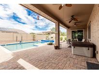 Backyard showcasing a pool, patio area, and outdoor seating at 9390 W Louise Dr, Peoria, AZ 85383