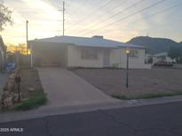 Charming single-story home with a carport and well-maintained front yard at 9846 N 10Th St, Phoenix, AZ 85020