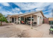 Welcoming covered front porch with cozy seating, perfect for relaxing outdoors at 1934 W Colter St, Phoenix, AZ 85015