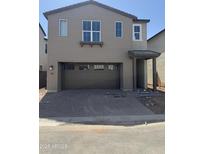Two-story home with a two-car garage and a covered entryway at 2467 W Rowel Rd, Phoenix, AZ 85085