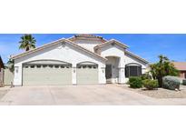 Charming single-story home with a two-car garage, desert landscaping, and a well-maintained front yard at 520 E Appaloosa Rd, Gilbert, AZ 85296