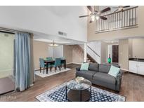 Open-concept living space with staircase, dining area, comfortable seating, and tile flooring at 5726 N 10Th St # 5, Phoenix, AZ 85014