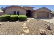 Charming single-story home with desert landscaping, stone walkway and a covered front porch at 2453 E Nathan Way, Chandler, AZ 85225