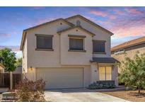 Charming two-story home with a two car garage and neutral colored stucco in a residential neighborhood at 567 E Bradstock Way, Queen Creek, AZ 85140