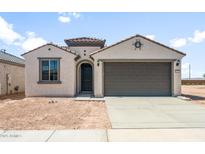 Charming single-story home with a neutral stucco exterior and a well-manicured lawn at 26992 W Melinda Ln, Buckeye, AZ 85396
