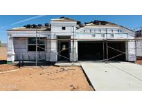 New home's exterior showing the initial stages of construction with scaffolding, roofing tiles, and wrapped insulation at 5064 E Midnight Star Dr, San Tan Valley, AZ 85143