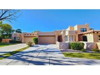 Charming Southwest-style home featuring a three-car garage, desert landscaping, and a tile roof at 5756 N 78Th Pl, Scottsdale, AZ 85250