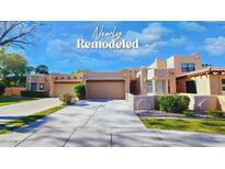 Newly remodeled desert home with a three-car garage, neutral tones, and lush landscaping at 5756 N 78Th Pl, Scottsdale, AZ 85250