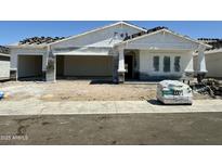 An exterior view of a new home with a three car garage and covered porch at 6452 E Omega Cir, Mesa, AZ 85215