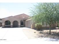 Charming single-story home featuring a stucco exterior, arched entryway, and easy to maintain desert landscaping at 8009 S 53Rd Ave, Laveen, AZ 85339