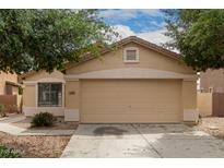 Tan single-story home with a two-car garage and desert landscaping at 10317 E Kiva Cir, Mesa, AZ 85209