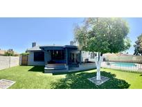 Expansive backyard with artificial turf, covered patio and gated pool, perfect for outdoor living at 10852 N 39Th Ave, Phoenix, AZ 85029