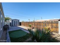 The backyard has a storage shed, hardscape, and mature landscaping, creating a private oasis at 10951 N 91St Ave # 6, Peoria, AZ 85345