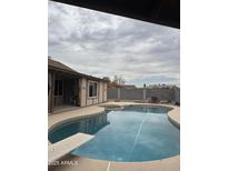Backyard pool with diving board and partially covered patio area perfect for entertaining or relaxing at 12512 N 85Th Ave, Peoria, AZ 85381