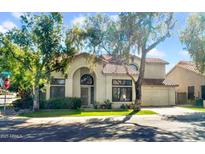 Charming two-story home with tile roof, well-manicured lawn, and mature shade trees at 155 W Knox Rd, Tempe, AZ 85284