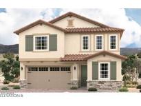 Charming two-story home with tan stucco, a red tile roof, stone accents, and green shutters at 17016 W Winston Dr, Goodyear, AZ 85338