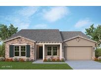 Charming single-story home with stone accents, a tile roof, and a well-manicured front yard at 21564 W Pierson St, Buckeye, AZ 85396
