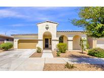 Charming single-story home with a two-car garage, arched entryway, and well-maintained front yard at 22472 E Sonoqui Blvd, Queen Creek, AZ 85142