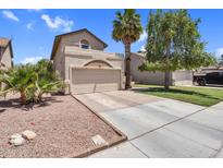 Beige two-story home featuring a two-car garage, manicured lawn, palm trees, and a driveway, set against a blue sky at 3608 W Harrison St, Chandler, AZ 85226