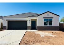 Charming single-story home with a dark gray roof, dark gray garage door, and xeriscaped front yard at 5106 E Midnight Star Dr, San Tan Valley, AZ 85143
