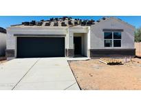 New construction home featuring a modern gray garage door and a bright white exterior at 5106 E Midnight Star Dr, San Tan Valley, AZ 85143