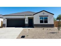 Charming single-story home featuring a black garage door and low-maintenance desert landscaping at 5106 E Midnight Star Dr, San Tan Valley, AZ 85143