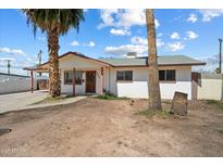 Charming single-story home featuring palm trees and a well-maintained yard in a quiet neighborhood at 946 S Pomeroy Cir, Mesa, AZ 85210