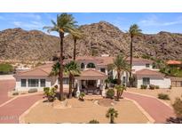 Stunning home featuring desert landscaping, terracotta tile roof, and mountain views at 11809 S Montezuma Ct, Phoenix, AZ 85044