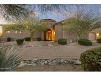 Elegant home entrance featuring a secure gated entryway, mature landscaping, and a desert-style front yard at 12006 E Yucca St, Scottsdale, AZ 85259