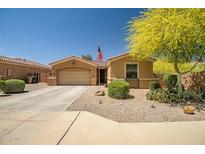Charming single-story home with desert landscaping, a two-car garage, and a vibrant yellow tree at 12690 S 184Th Ave, Goodyear, AZ 85338