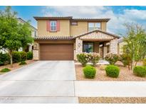 Charming two-story home with a well-manicured front yard and a two-car garage, perfect for suburban living at 17424 W Willow Ave, Surprise, AZ 85388