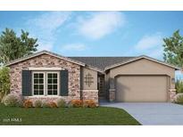 Charming single-story home features a brick facade, neutral stucco and a two-car garage at 21612 W Pierson St, Buckeye, AZ 85396